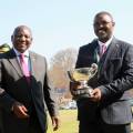 Republic of South Africa President Cyril Ramaphosa hands over trophy to GMB CEO Dr Edson Badarai